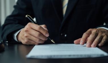 hand signing a paper